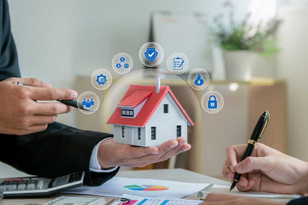 Tenant reviews an insurance policy beside a laptop, receipts, and a home inventory checklist.